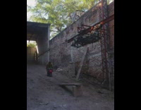 man rides a mini bike off a make shift wooden ramp