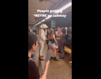 Man wearing suit sings at subway station