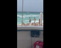 Woman bikini wide leaves on back beach