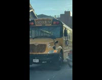 Yellow bus stuck in the middle of the street 