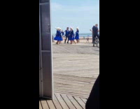 Dance group films video at the beach