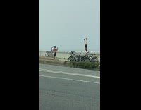 Girl black shorts handstand pose bike overcast