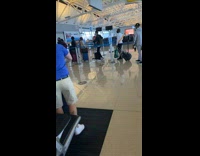 Guy Carries Chucky Doll in Airport Line 