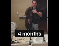 Guy holds up brown puppy each month