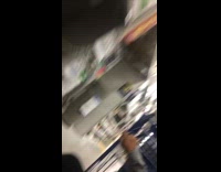 Guy pushes girl in blue shopping cart down store aisle girl falls off cart