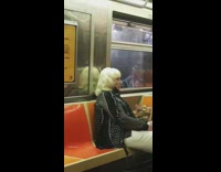 Grandma black face mask under chin subway