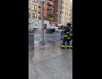 Firemen shoot water at call box street