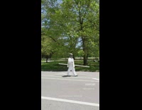 Person at park wears welders mask sign