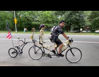 Man rides quad tandem bike with skeleton