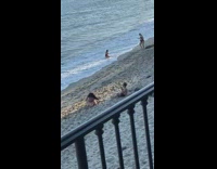 Two different girls pose beach sand balcony 