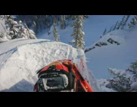 POV of guy riding snowmobile off cliff