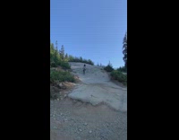 Biker falls forward down hill 