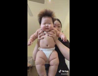 Mom carries chubby baby 