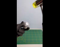 Man molding foil into ball 