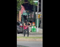 Guy plays electric guitar in the middle of the street 