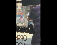 Man pulls down pants and poops on sidewalk then takes blue hat and wipes butt