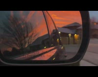Sunset sky view from car side mirror