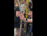 Woman holds book called I love Dick on the subway train