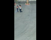 Woman in purple poses in neighborhood 