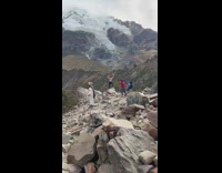 Man shirtless flexes back muscles at the rocky mountains