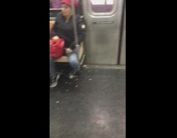 Woman throws pumpkin seeds on the floor after eating them on subway train