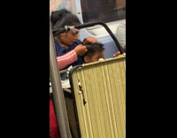 Woman eats lice from hair of boy