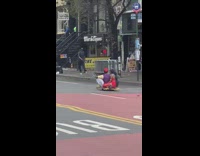 Couple dressed in Aladdin Jasmine halloween costume and ride on magic carpet down the street, daylight