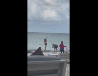 Woman red bikini left arm up beach