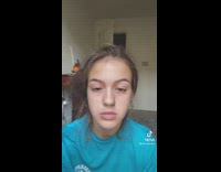 Lady scratches her face while filming dance video