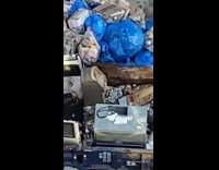 ATM left out on sidewalk with trash 