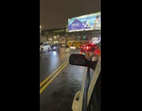 Yellow school bus blocks intersection night time