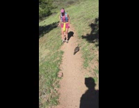 Woman chased by a bird on the trail