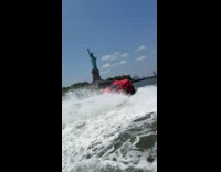 Guy drives red car in the river