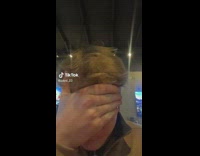 Man cover eyes while girlfriend pays for bill