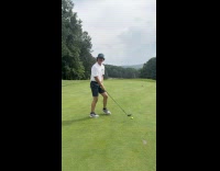 Man golfing hits ball backwards
