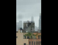 Woman black shirt selfie rooftop windy storm