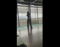 Woman in black crop top tiktok dance at the airport