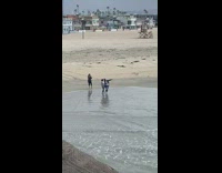 Girls have photoshoot on beach sand 