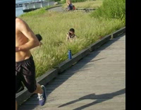 Guy girl squat tall grass river park 