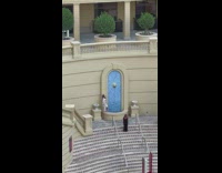 Woman in white dress poses on the water fountain