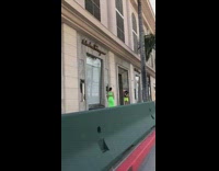 Two woman green dress photo shoot sidewalk