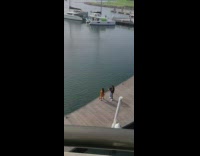 Woman orange dress tiktok video at the dock