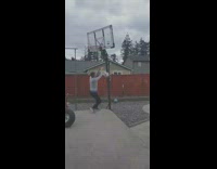 Guy dribbles dunks white soccer ball hoop 