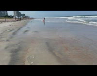 DDOI logo drawn on beach sand ocean