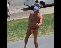 Naked man in thong does yoga in park