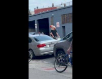 Man riding bike wearing phineas head mask