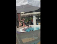 Woman in black bikini lie down by the poolside