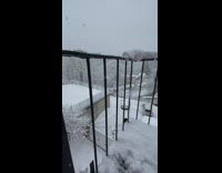 Tiny snowman wearing paper cup hat outside