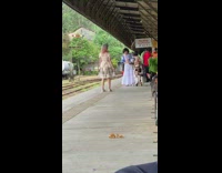 Woman white dress jump shot train station