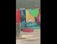 White hat guy poses colorful wall mural 